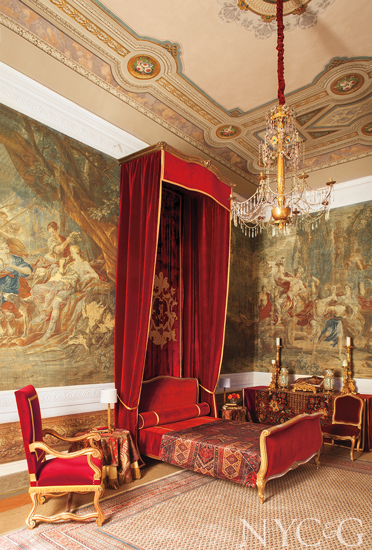 An elaborate bedroom with red velvet bed in Lucca, Italy