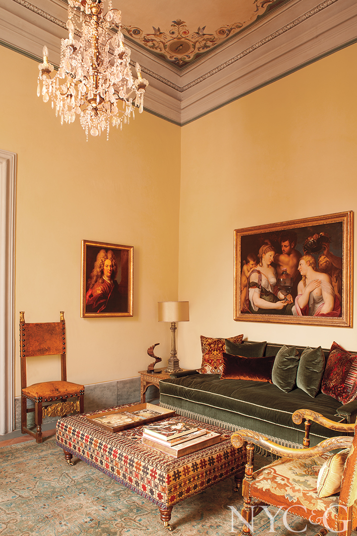 Chandelier, sofa and ottoman in traditional fabrics.