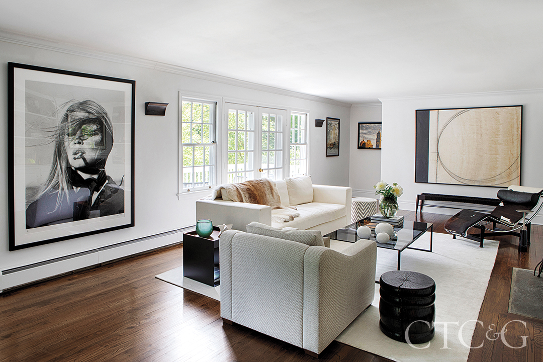 wall art in living room; lounge chair, chaise, and sconces