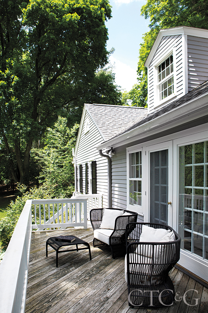 black rope chairs with white seat cushions on back deck