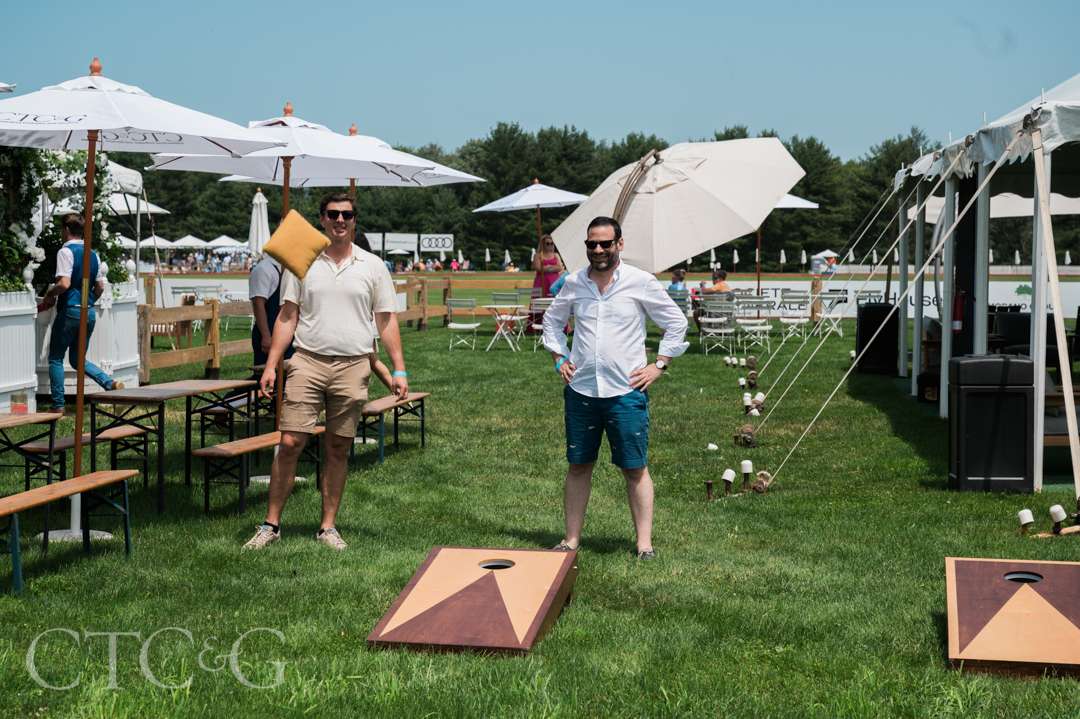 Guests playing cornhole at CTC&G Players' Lounge at Greenwich Polo Club