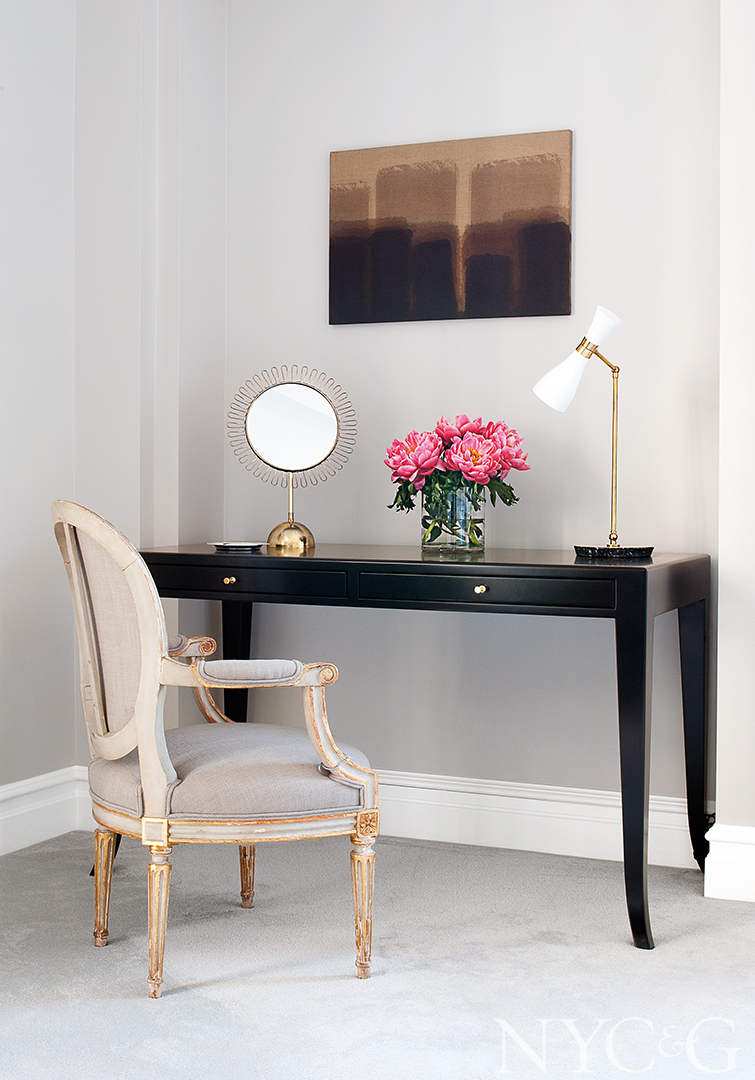 A vintage Louis XVI–style fauteuil adds luxury to office