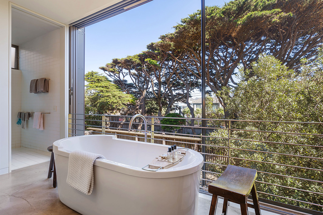 Bathtub with floor to ceiling glass windows and beautiful views