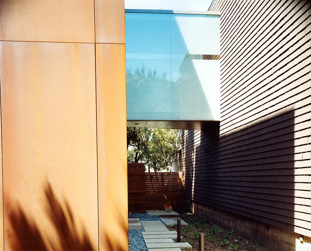 Bridge connecting two modern homes