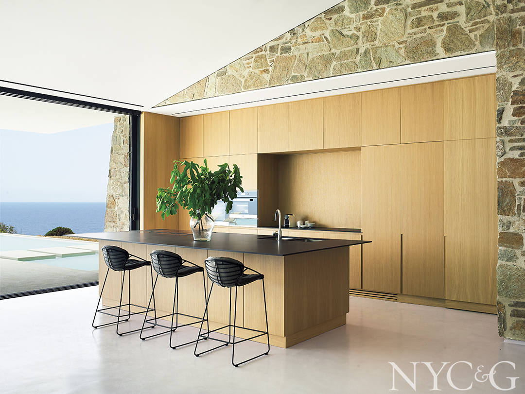 contemporary wood paneled kitchen with island and bar stools
