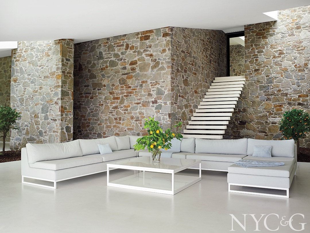 Simplistic living room with white couch and white coffee table.