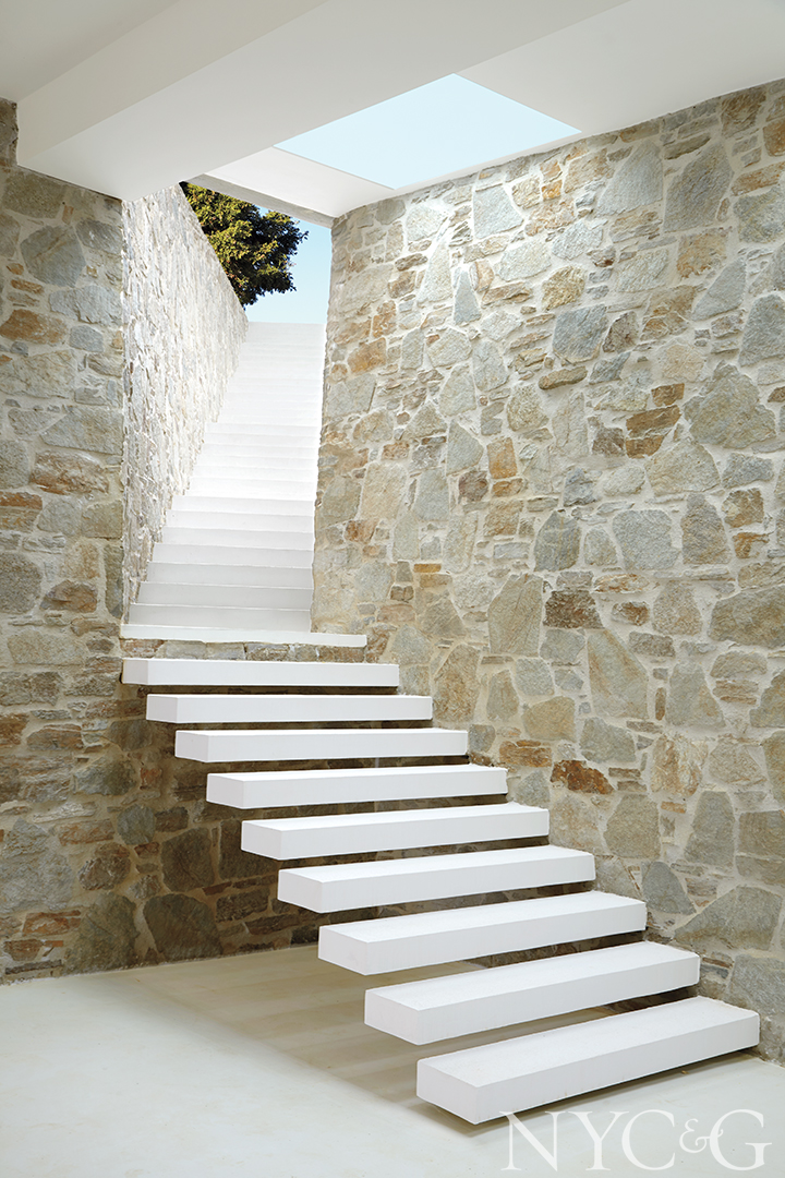 white staircase and stone walls