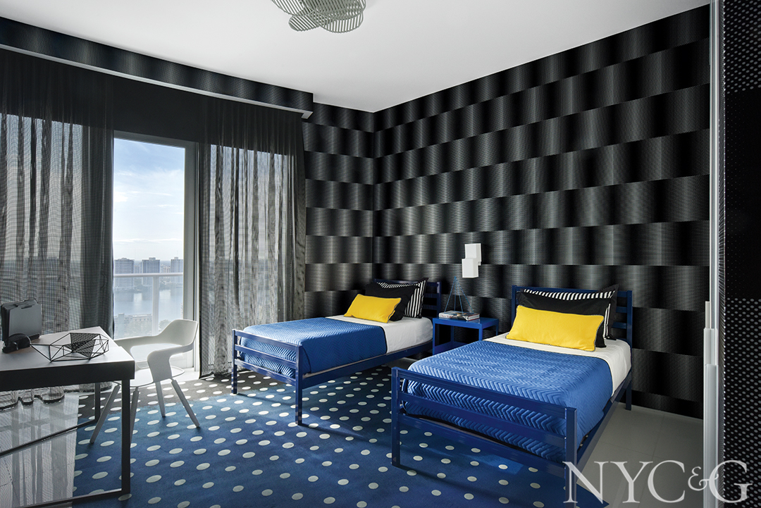 guest room with black patterned walls and blue and yellow details