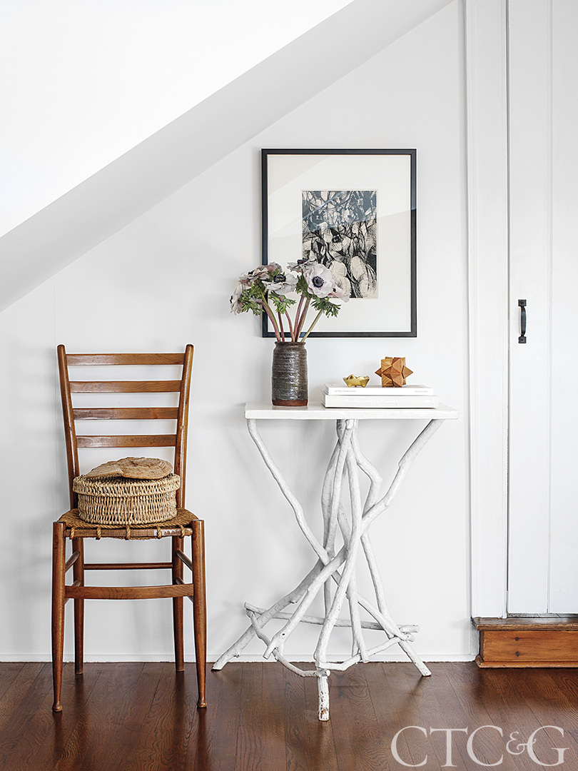 Side chair and painted white branch side table with artwork and accessories