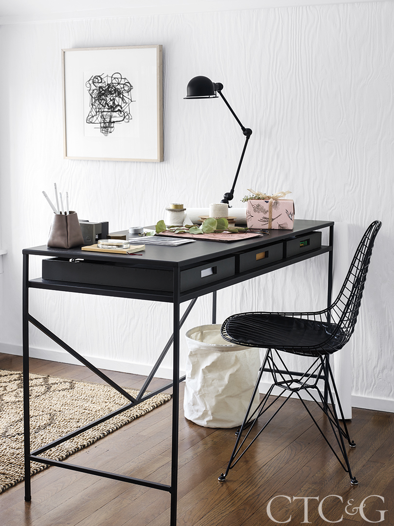 black desk with black eames desk chair and sisal rug