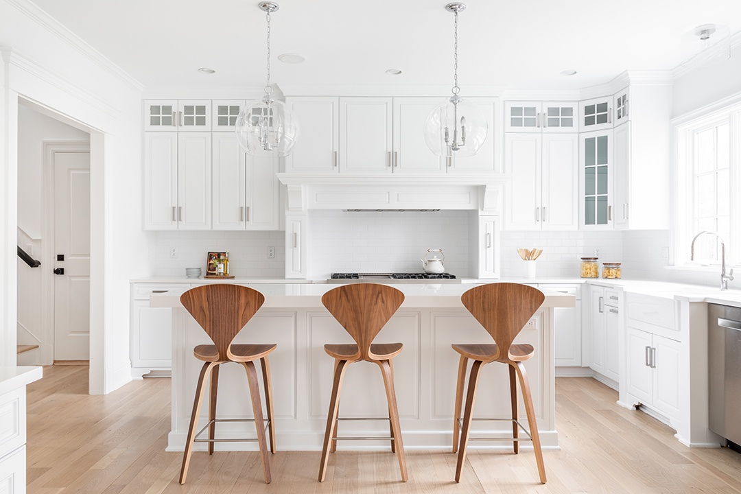 Bright white kitchen with trendy light fixtures