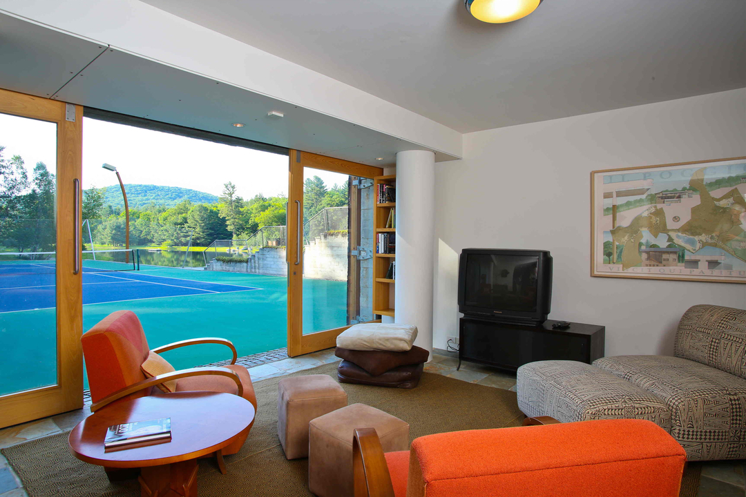 Den next to tennis court