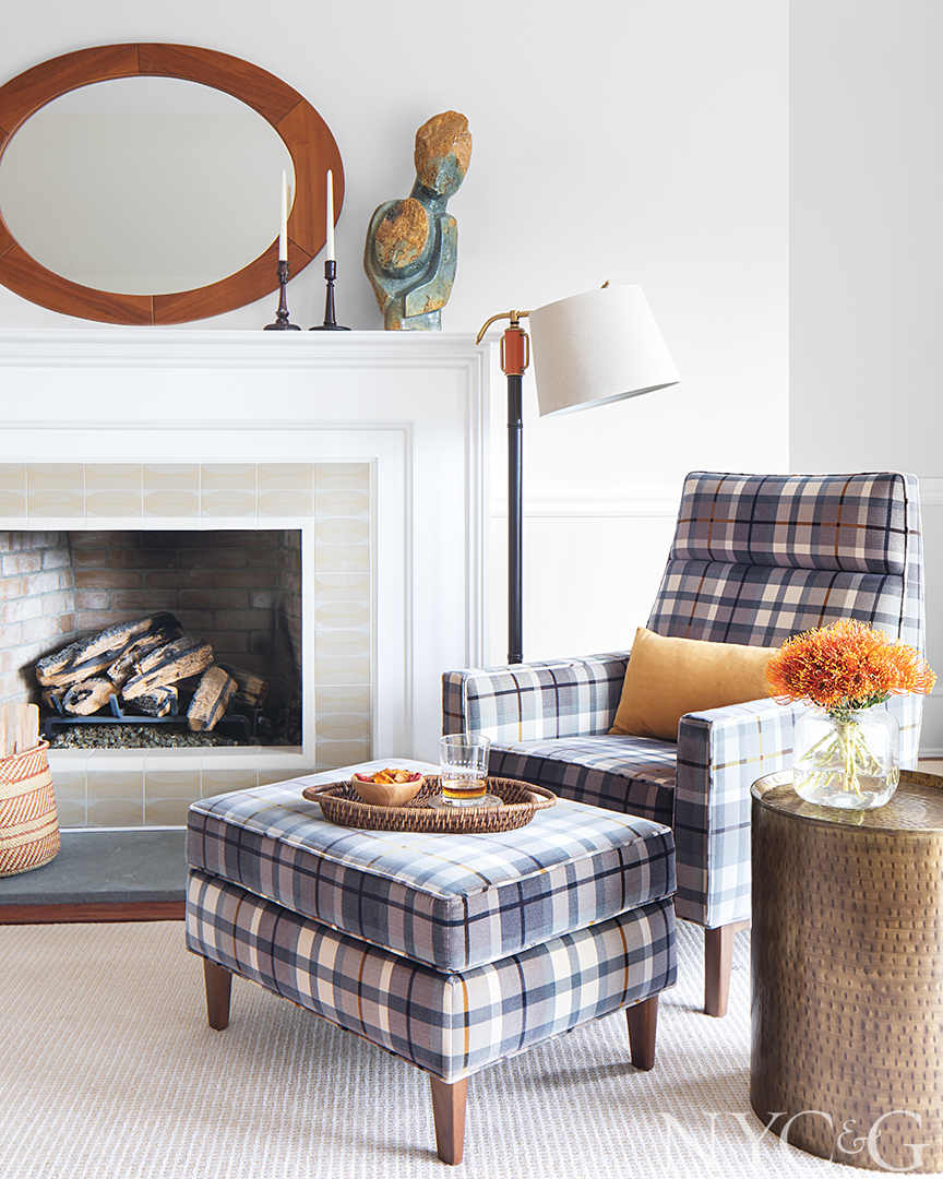 master sitting room with plaid fabric and a fireplace