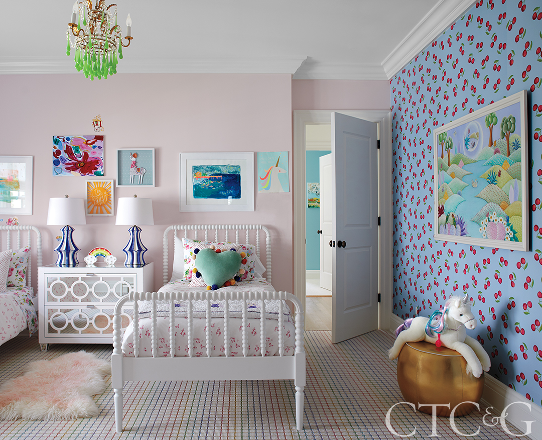 girls bedroom with cherry wallpaper and a patterned rug