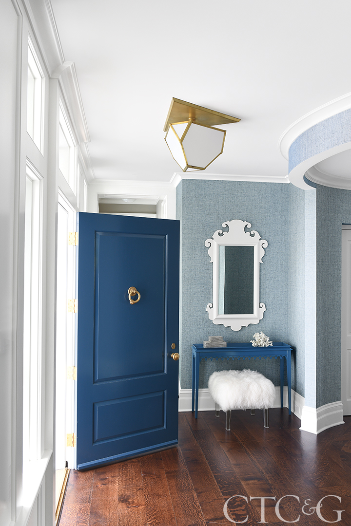 Blue door entry compliments the blue walls and dark floors.