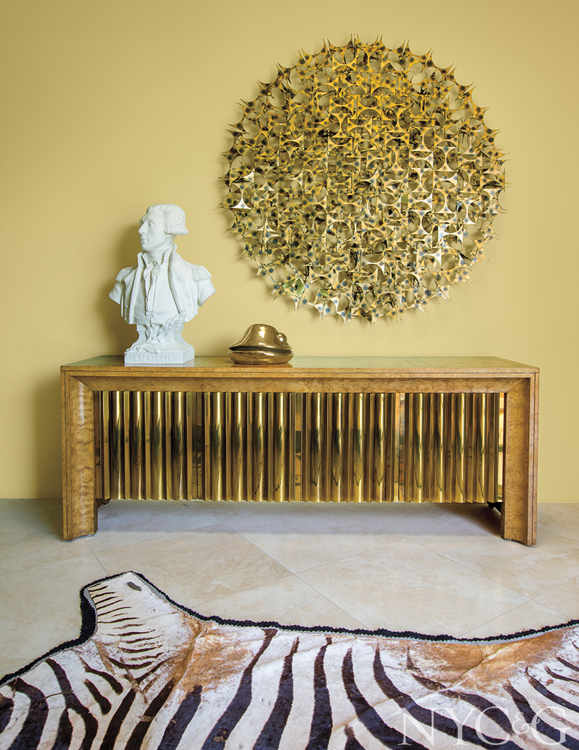 Table with gold and brass finishings and an animal print rug.