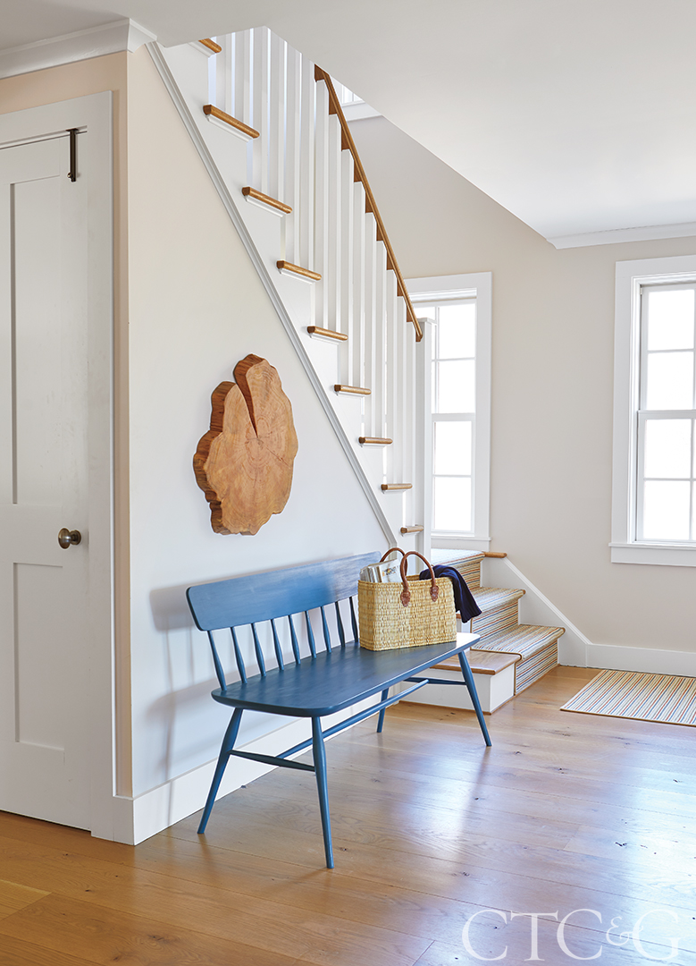 white hallway with blue bench