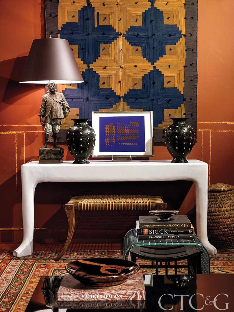 Table with various contemporary pieces of decor and artwork.