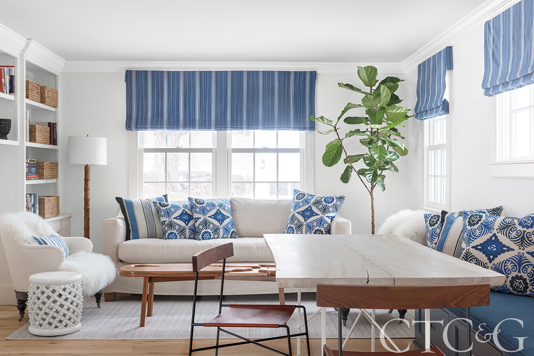 Family living room with couches, dining table and blue accents