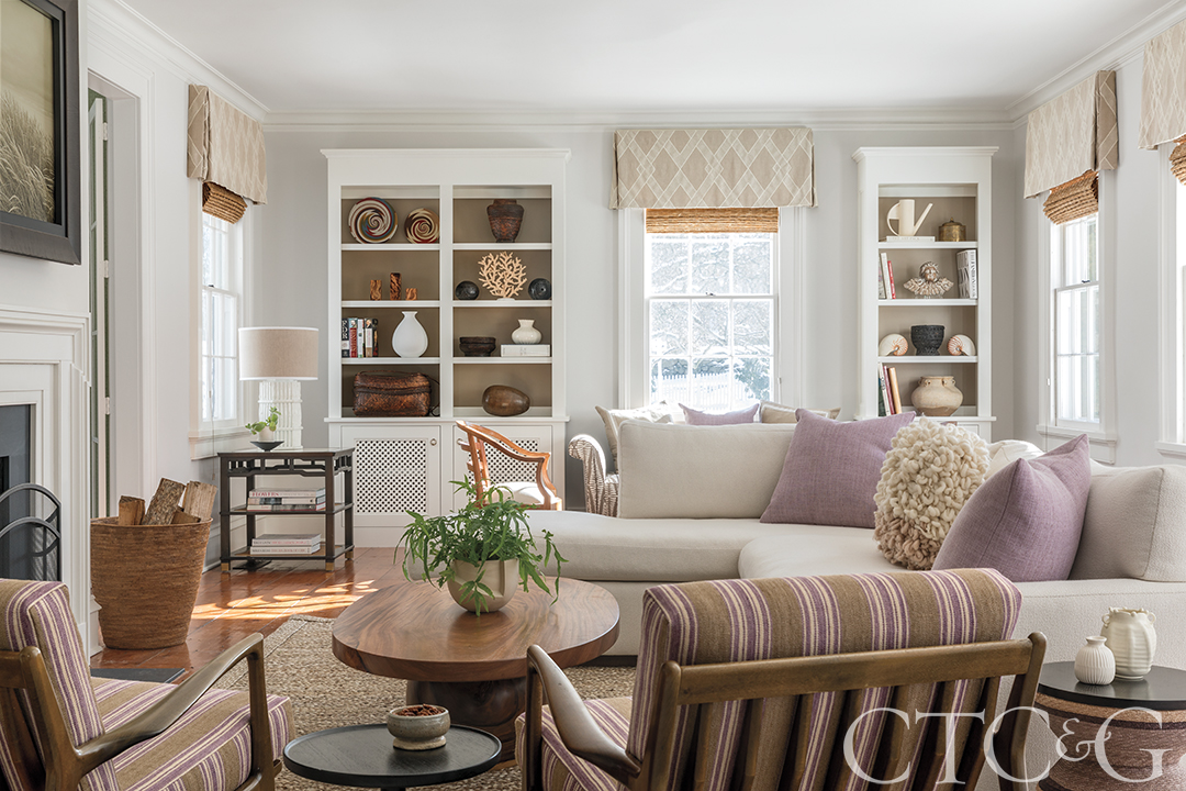 living room with warm tones, fireplace and white walls