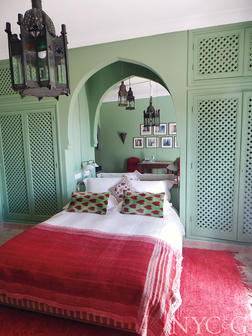 Bedroom with green walls and pink accents.