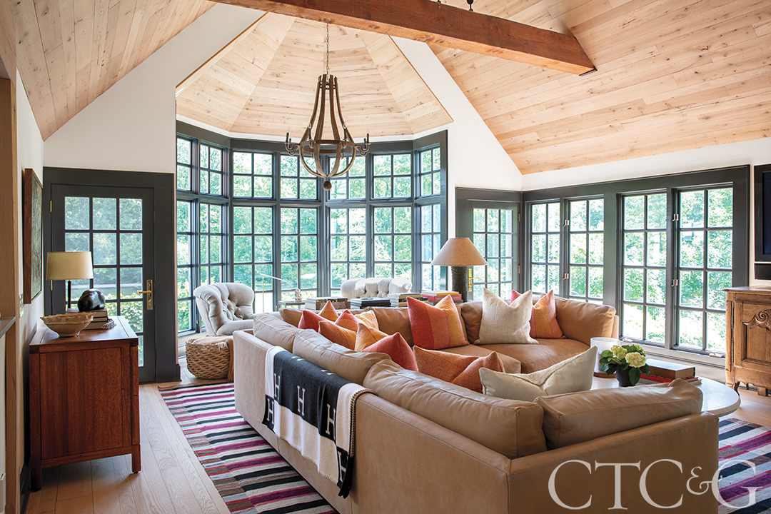Family room with coaches, beamed ceiling, and large windows