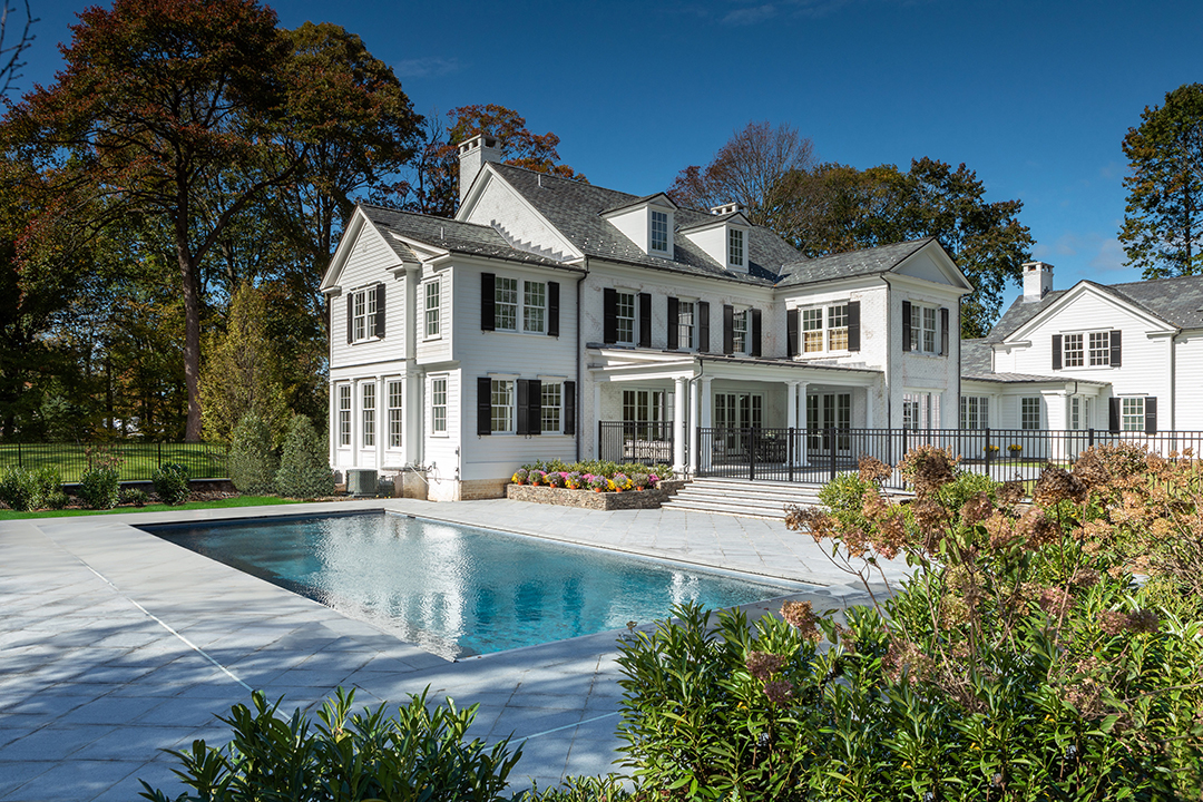 white colonial with black details estate backyard