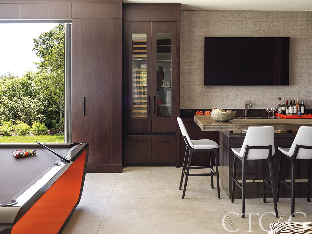 Bar area with blue cabinets and a sliding barn door