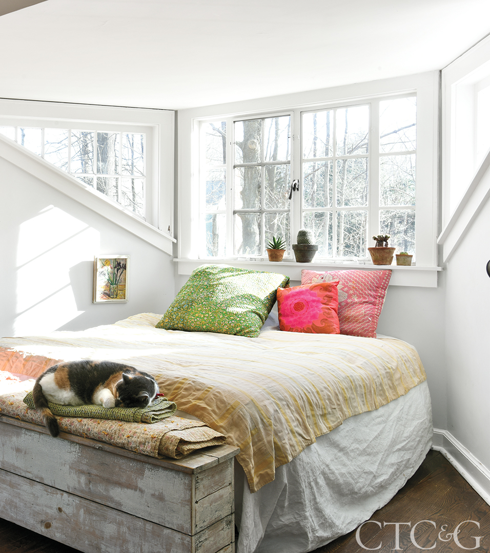 white bedroom with windows and cat
