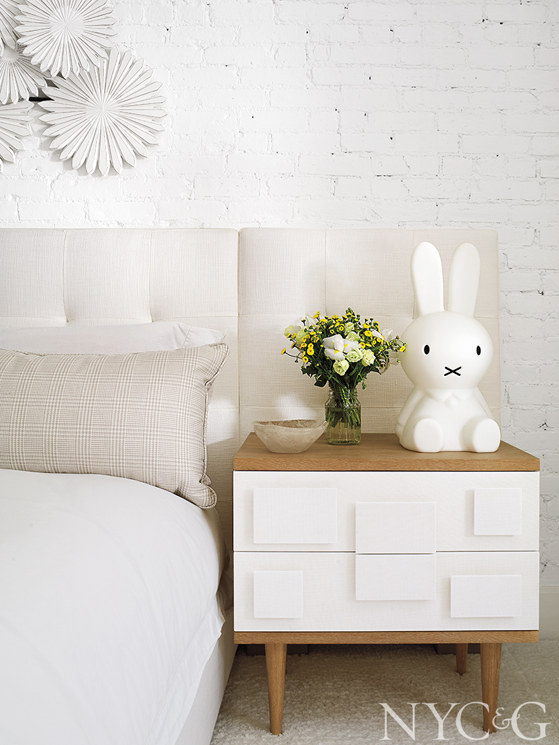white bedroom night stand with quirky decor