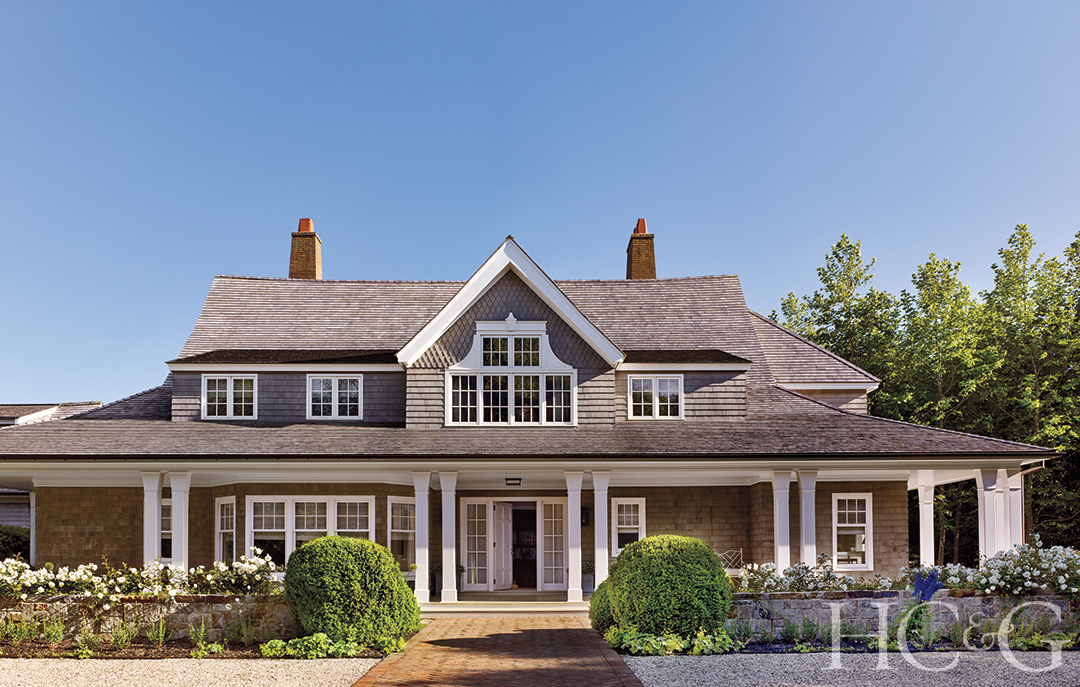 The exterior of a shingle style home.