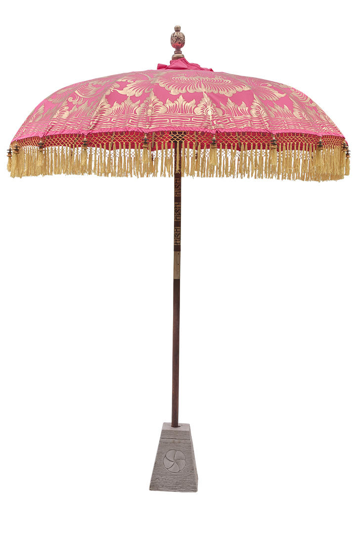 A pink parasol with intricate gold detailing and tassels.