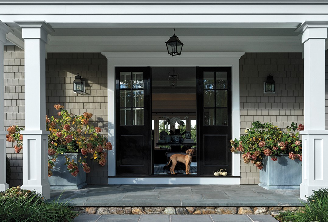 front entryway to home framed by RH planters