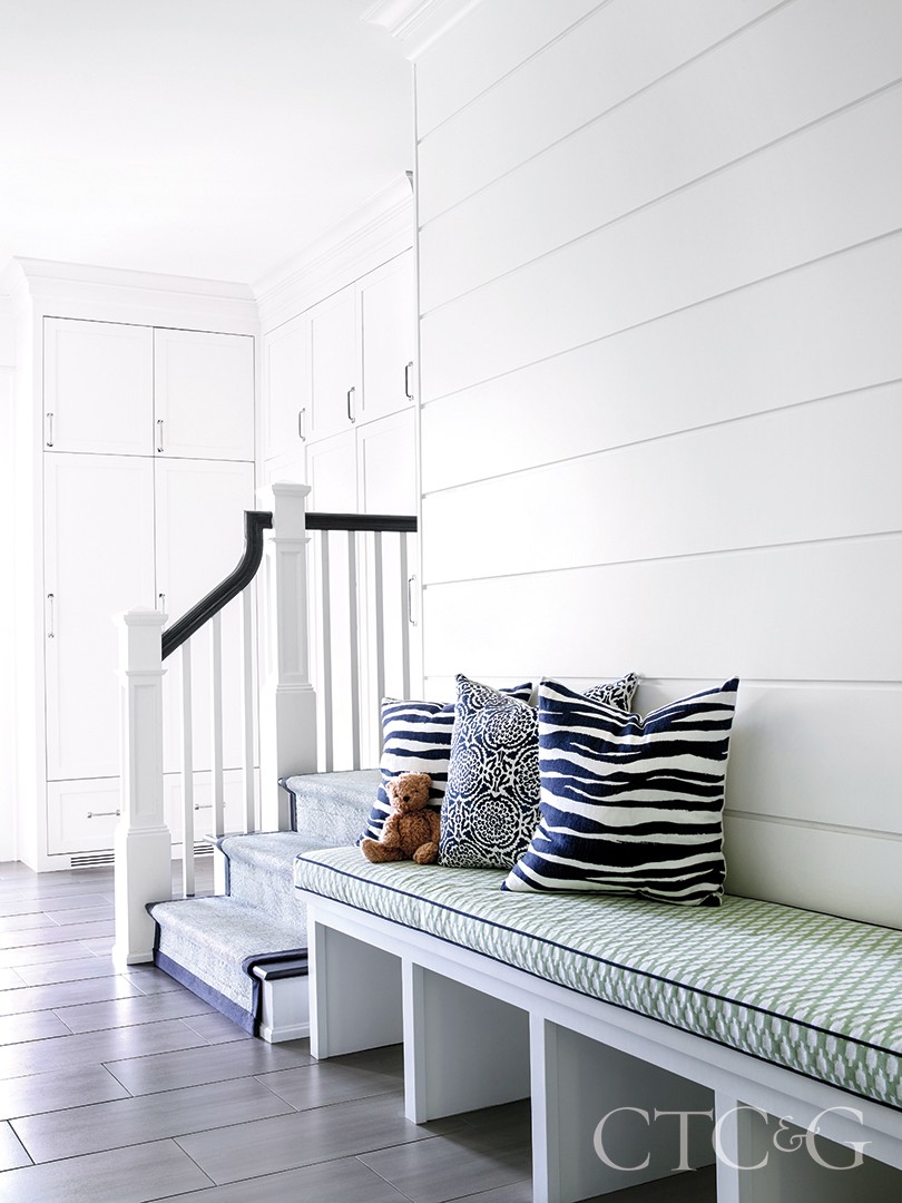 bright green patterned bench and cushions in back entrance mudroom