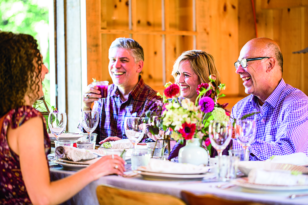 Guests At Barn Supper Dining Table