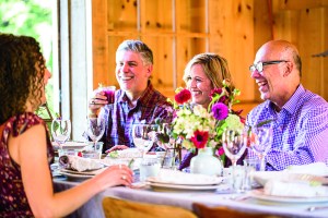 Guests At Barn Supper Dining Table