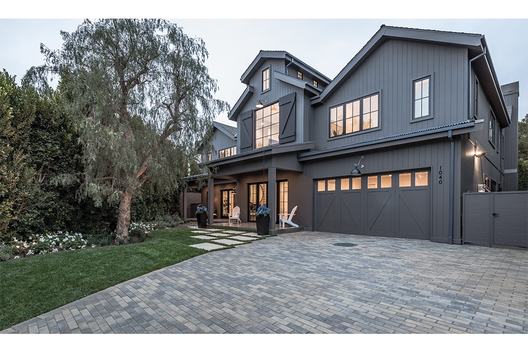 Black Home Exterior With Stone Driveway