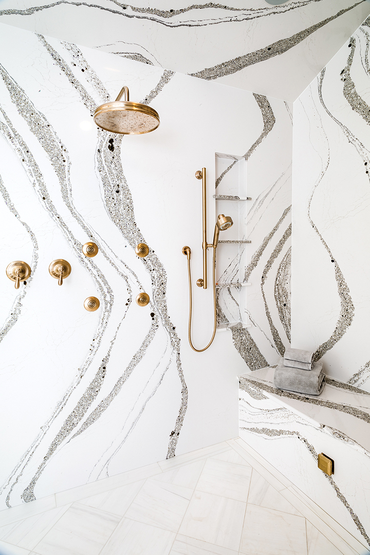 quartz walk in shower with gold hardware