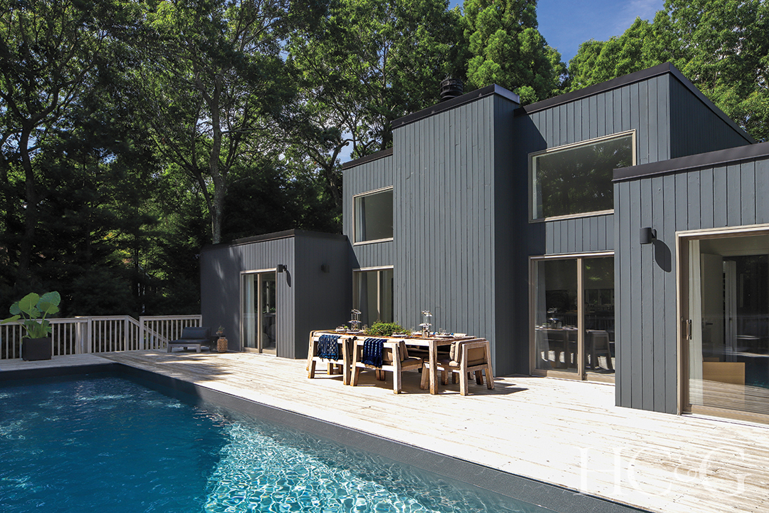poolside dining area with wood table and chairs
