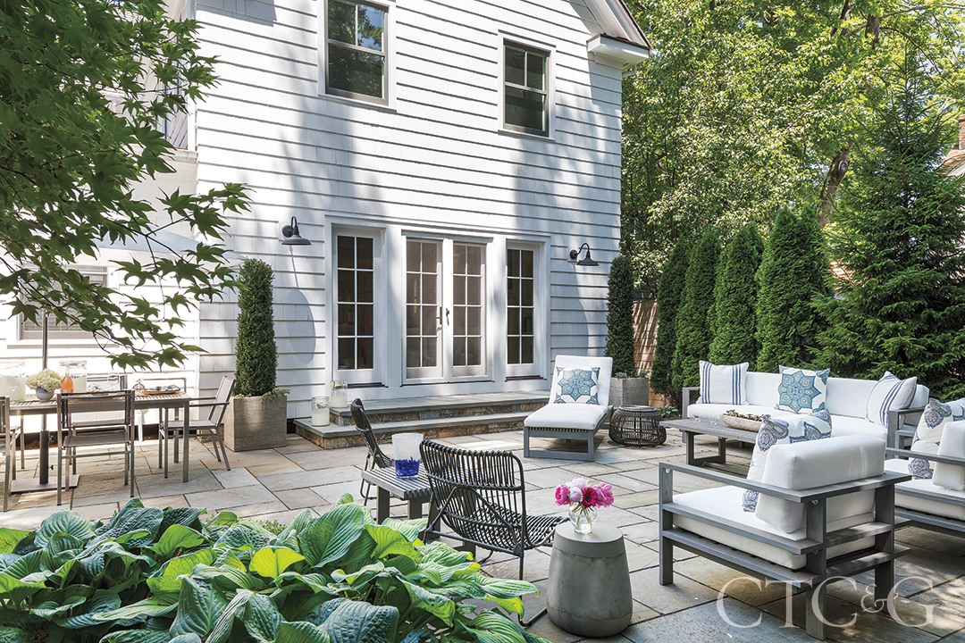 Outdoor living area with couch and chairs