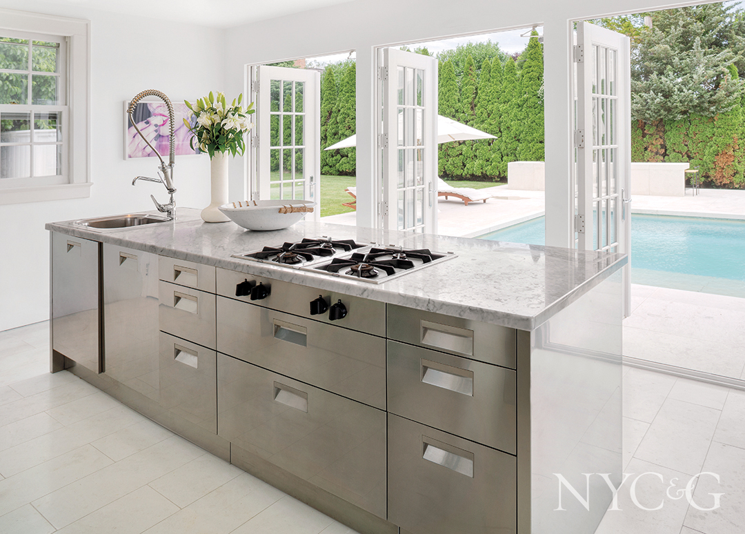 custom island with cooktop and marble counter