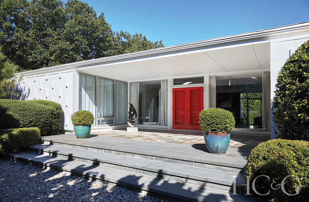 Wide Home Entrance with Large Windows and Red Door