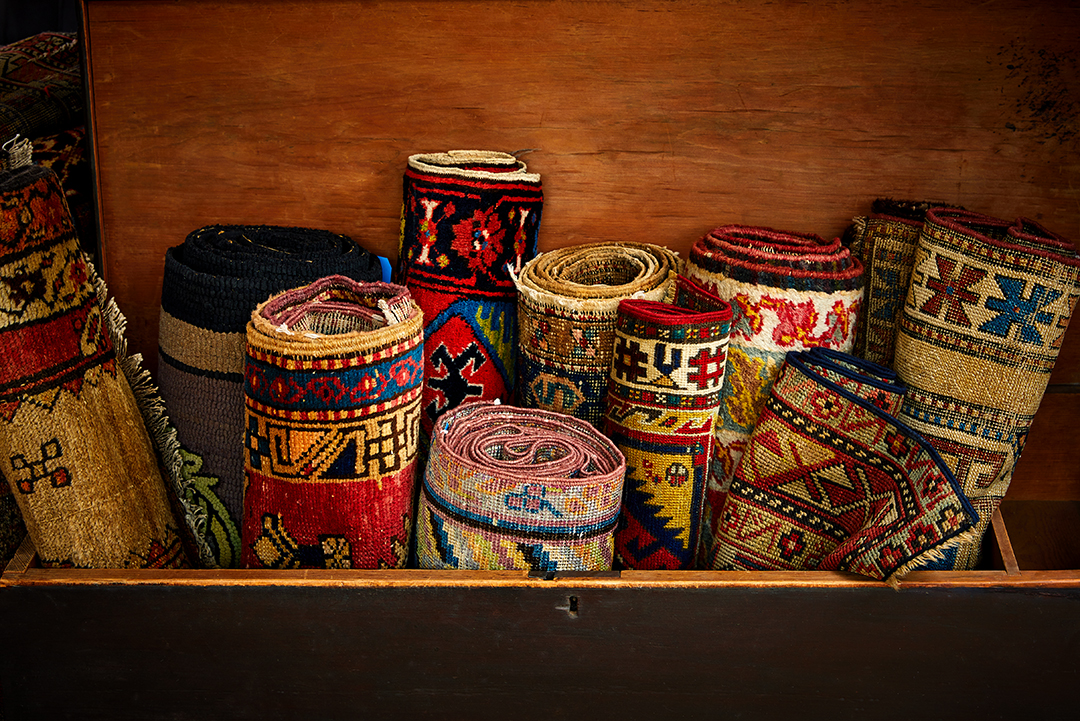Group Of Rolled Up Antique Rugs