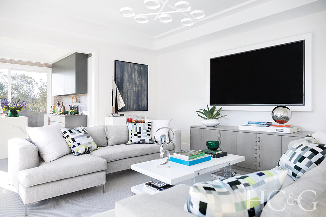 custom gray sofas, decorative pillows, and coffee table