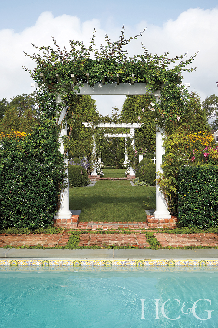 rose-covered arched trellises by the pool