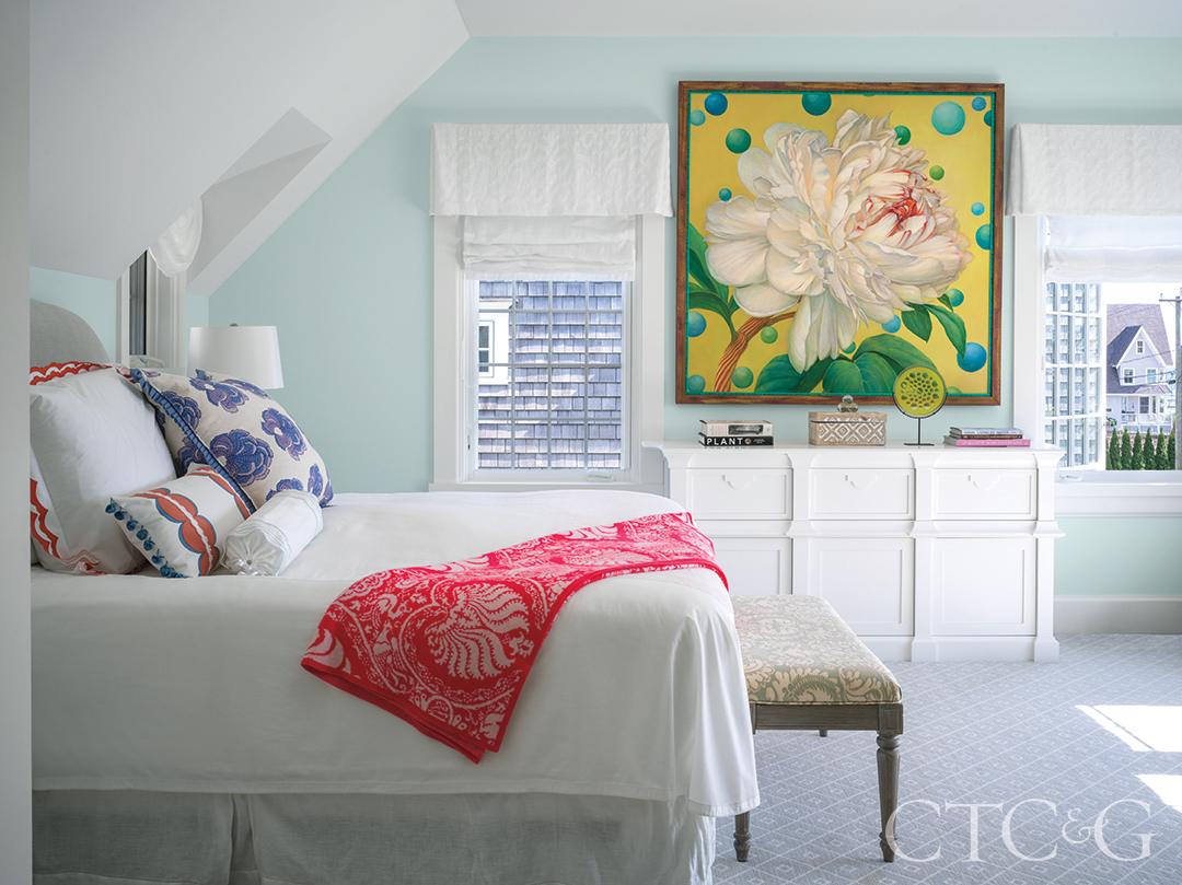 floral painting, bed, and Roman shades in primary bedroom
