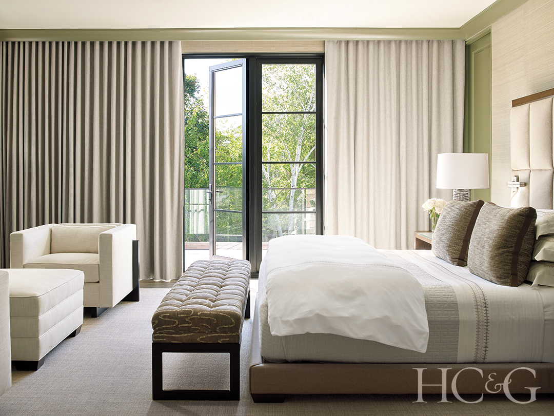 primary bedroom suite; bed, armchairs, and night tables