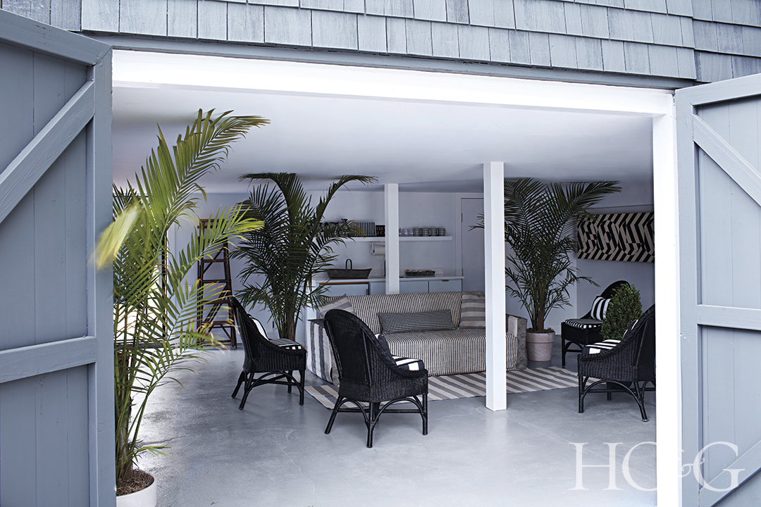 converted pool house with outdoor furniture and ferns