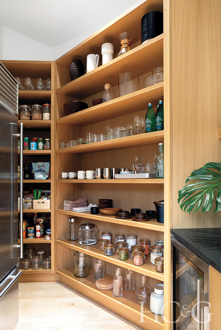 rift-oak pantry shelves and black kitchen counters