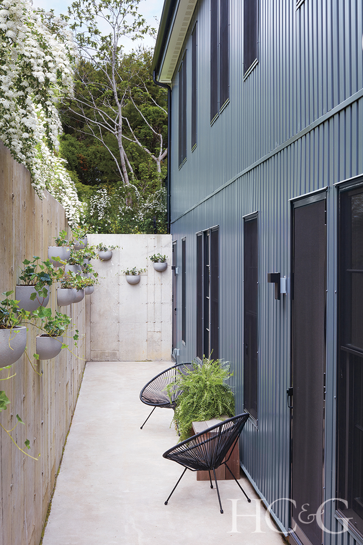 cement-lined sunken terrace hung with planters